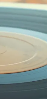 Close-up of a spinning vintage vinyl record with a blue-gray tone.