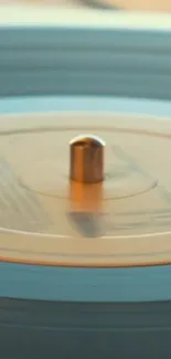 Vintage turntable with a spinning vinyl disc in focus.