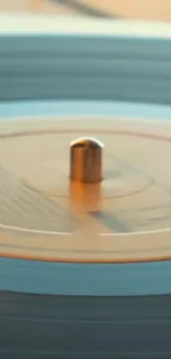 Close-up of a spinning vinyl record with a blue-gray hue.