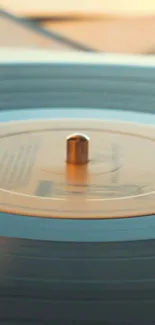 Close-up of a spinning vinyl record with a retro aesthetic in warm tones.