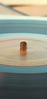 A spinning vintage vinyl record with warm beige tones.