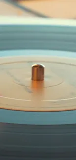 Close-up of a spinning vinyl record with warm golden tones.