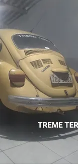 Vintage yellow Volkswagen Beetle parked indoors.