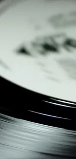 Black and white close-up of a spinning vinyl record.