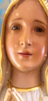 Virgin Mary statue in soft golden hues on a mobile wallpaper.