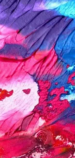 Vivid abstract wallpaper with red, blue, and pink paint textures.