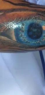 Detailed blue eye tattoo design for mobile wallpaper.