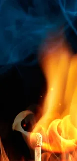 A vibrant match flame with blue smoke on black background.