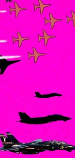 Silhouette of jets against a vibrant pink background.