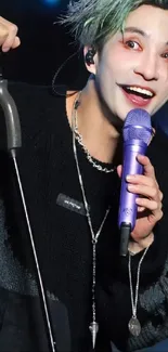 Dynamic performer with green hair and expressive makeup holding a microphone.