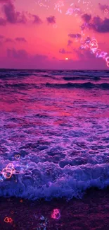 Vivid pink sunset over ocean waves with dramatic sky.