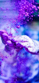 Hands in purple dust creating a vibrant splash effect.