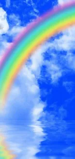 Colorful rainbow arches over a blue sky and water reflection.