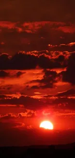 Vibrant red sunset with dramatic clouds on the horizon.