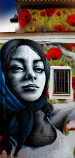 Street art mural featuring a woman with vibrant red flowers and blue scarf.