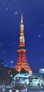 Tokyo Tower illuminated against night sky with cityscape.