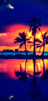 Tropical sunset with palm trees reflected on water.