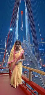 Woman in traditional attire on a vibrant city bridge at night.