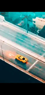 Aerial view of yellow car on a bridge with a teal urban backdrop.