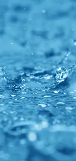 Vivid blue water splash with droplets on a mobile wallpaper.