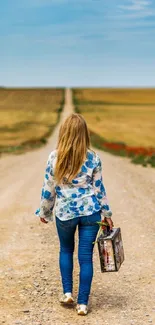 Lone traveler walking down a rural road towards the horizon with a suitcase.