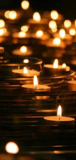 Cozy candlelight glow with numerous small tea lights in darkness.