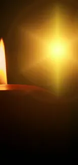 A glowing candle against a dark background, creating a warm ambiance.