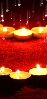 Cozy candlelight on red background mobile wallpaper with star effects.