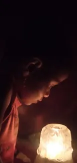 Child illuminated by warm candlelight glow.