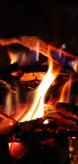 Close-up of logs with bright flames in a cozy fireplace setting.