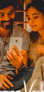 Two friends sharing smiles while looking at a phone, creating a warm, joyful scene.