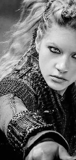 Black and white wallpaper of a fierce warrior woman with piercing eyes.