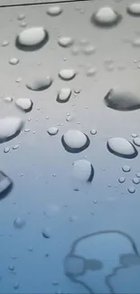 Raindrops on a cool blue surface creating a serene visual effect.