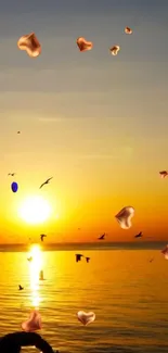 Beautiful sunset with heart shapes and birds over a serene ocean view.