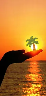 Hand holding a digital palm tree at sunset by the ocean.