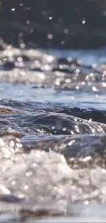 Serene river glistening under sunlight with gentle water flow.