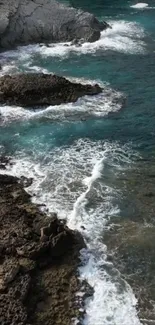 Rocky coastline with ocean waves and teal waters.