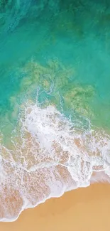 Turquoise ocean waves crashing on sandy beach.