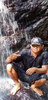 Man poses by a waterfall, exuding adventure and tranquility.