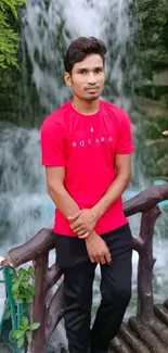 Person in red shirt by scenic waterfall.