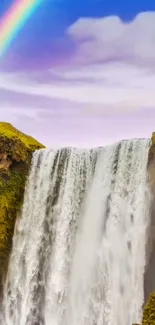 Waterfall with a rainbow in a serene landscape.