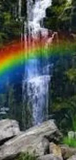 Waterfall with rainbow in lush green forest.