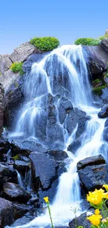 Serene waterfall with rocks and colorful foliage.