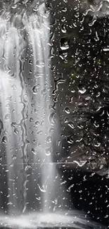 A mobile wallpaper featuring a cascading waterfall behind rain droplets.