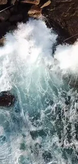 Aerial view of ocean waves crashing against rocky cliffs.