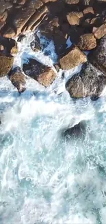 Aerial view of waves crashing on rocky shore with foamy water.