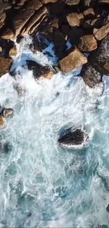 Aerial view of ocean waves crashing over rocks.