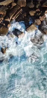 Aerial view of waves crashing on rocky shore.