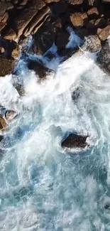 Aerial view of ocean waves crashing on rugged rocks.