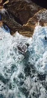 Aerial view of waves crashing onto rocky coastline.